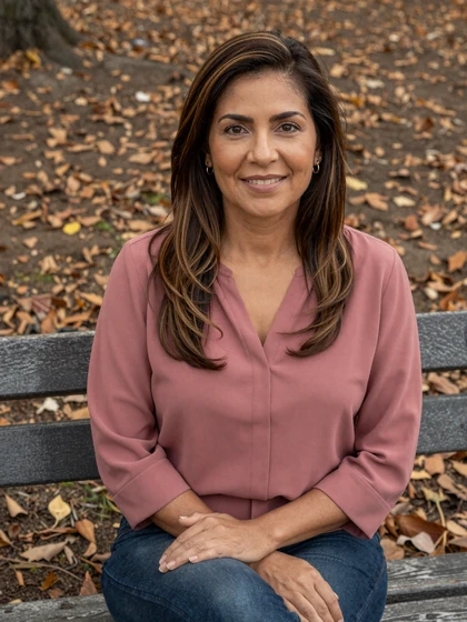 Patricia, 47, mature single Datempire member sitting on an autumn park bench in a rose pink blouse